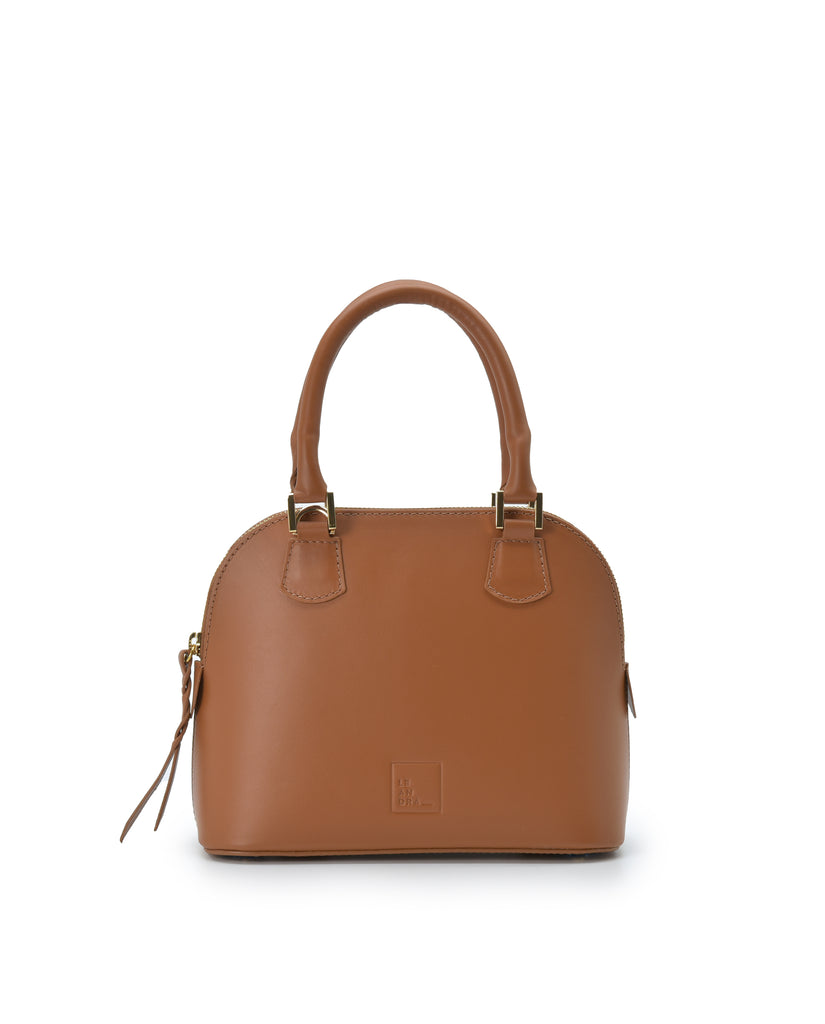 Imagen frontal con asa de mano del bolso de mano mini de piel color camel Leandra. Bolsos de piel fabricados en Ubrique Made in Spain