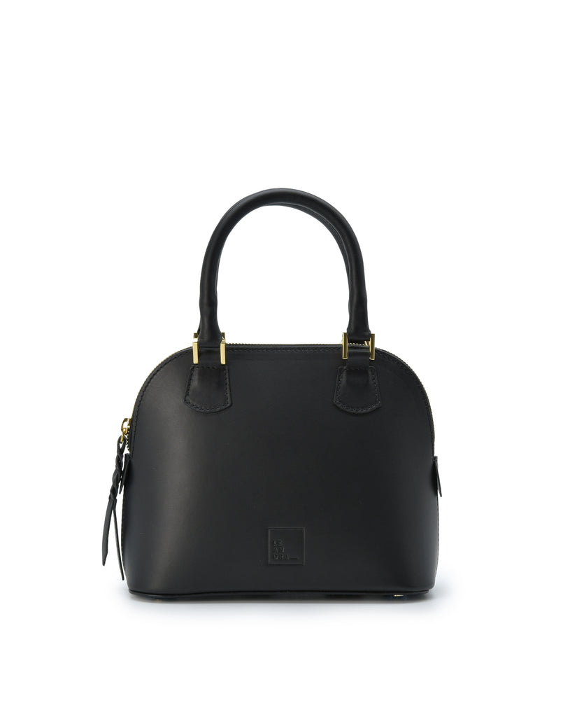 Imagen frontal con asa de mano del bolso de mano mini de piel color negro Leandra. Bolsos de piel fabricados en Ubrique Made in Spain