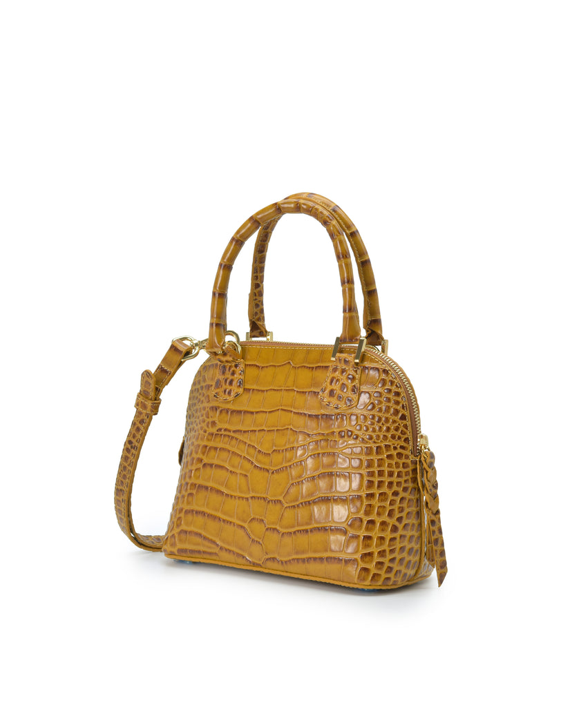 Imagen lateral de bolso de mano mini de piel grabada en coco color camel Leandra. Made in Spain