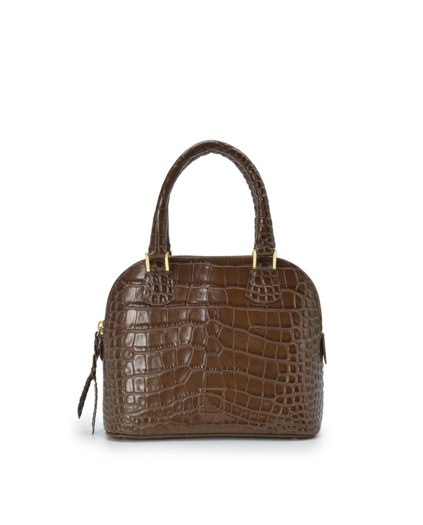 Imagen frontal con asa de mano del bolso de mano mini de piel grabada en coco color marrón Leandra. Bolsos de piel fabricados en Ubrique Made in Spain