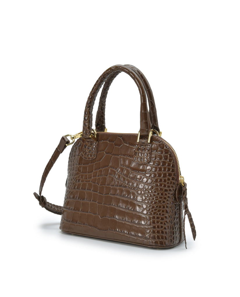 Imagen lateral de bolso de mano mini de piel grabada en coco color marrón Leandra. Made in Spain