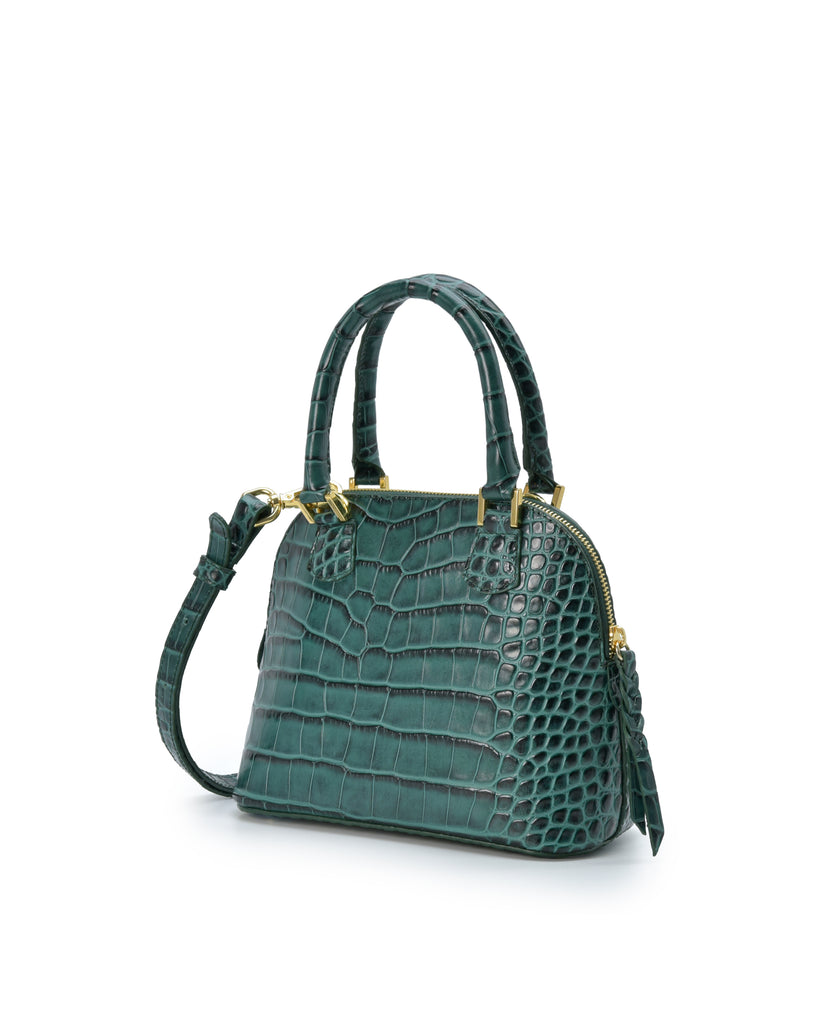 Imagen lateral de bolso de mano mini de piel grabada en coco color verde Leandra. Made in Spain