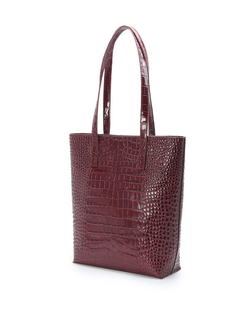 Imagen lateral de bolso shopper multiposición de piel grabada color burdeos con cremallera Leandra. Bolso made in Spain