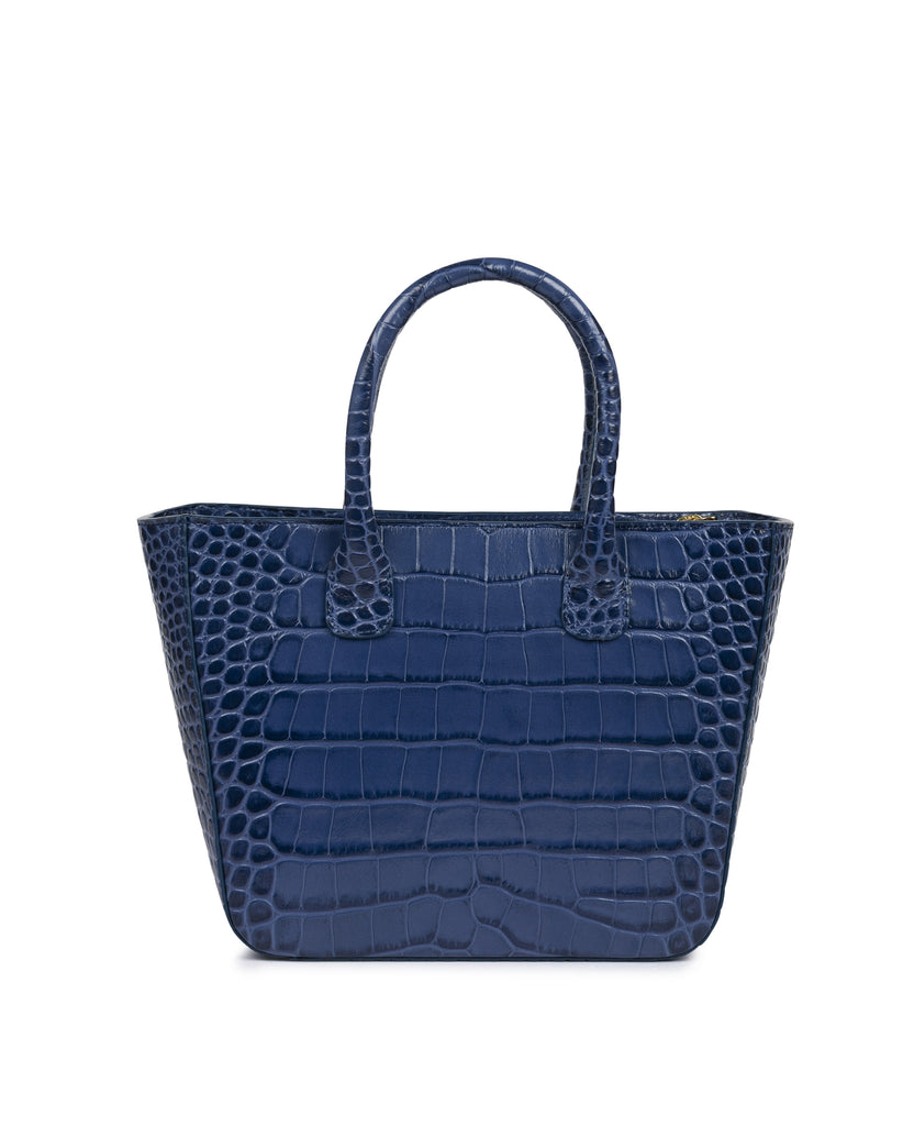 Imagen frontal sin asas de bolso de mujer de mano de piel grabada en coco color azul tipo trapecio con asa tipo bandolera Leandra