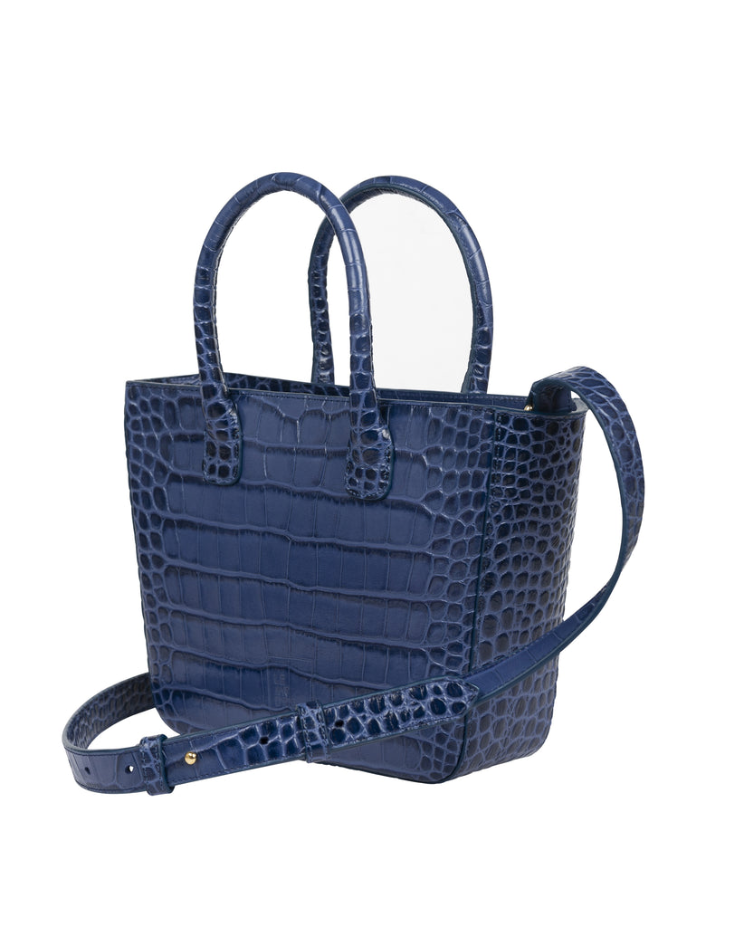 Imagen frontal de bolso de piel de mujer Leandra. Bolso tipo trapecio de color azul de piel grabada en coco Leandra a la venta en leandrabrand.com